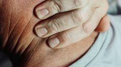 Close-Up Photo of a Person Having a Neck Pain