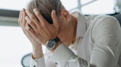 A Man Places His Hands on His Head
