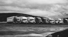 Parked Trucks Under Clouds