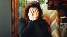 Person Covering Face with Hands