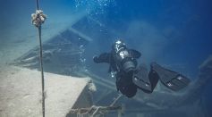 Person Diving Deep in the Ocean