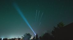 Person Flashing Light to the Stars